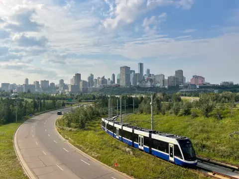 A Valley Line LRT train with the downtown Edmonton skyline behind it